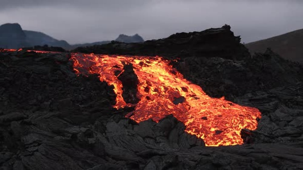 Glowing Lava Flowing Over Volcanic Rocks at Night, Nature Stock Footage ...