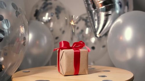 Festive Gift with Sparkler and Shiny Balloons