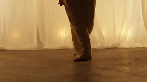 Closeup of a Professional Dancers Legs Performing in Studio in Soft Warm Lighting