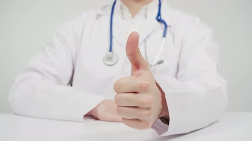Doctor giving thumbs up sign