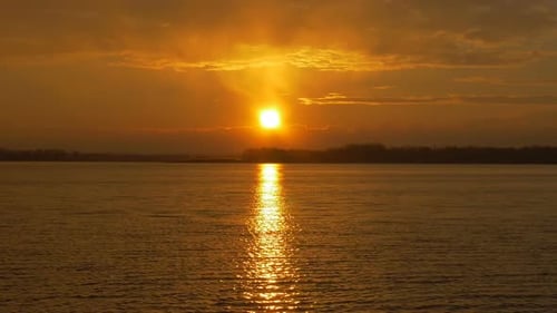 Colour Sunset Over The River With Sun And Orange Clouds