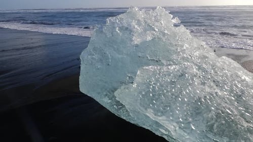 Iceland Jokulsarlon Diamond Beach With Iceberg Ice Chunks On Black Sand Ocean Shoreline
