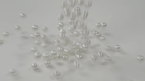White Pearls Falling on White Surface