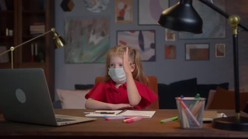 Girl Attending Remote Learning with Mask at Desk