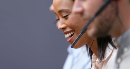 Lächelnde Kundenservice-Führungskräfte sprechen am Schreibtisch über Headset