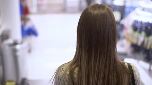 woman walking in a clothes store