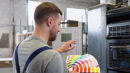 Graphic Designer Choosing Colors From Color Palette