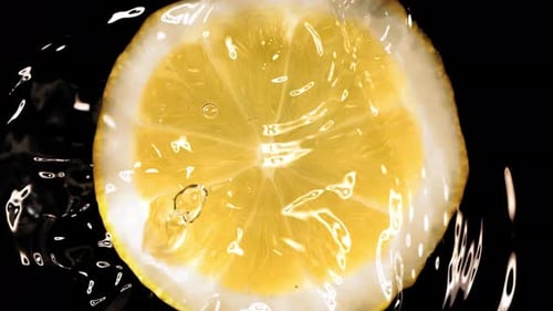 Super Slow Motion of Falling Water Drop on Lemon Slice