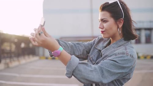 Woman Happily Taking Selfies in an Urban Area