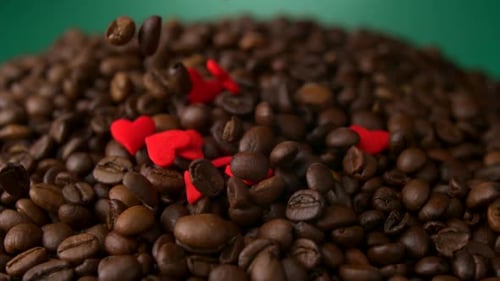 Coffee Beans with Red Hearts Falling Close Up
