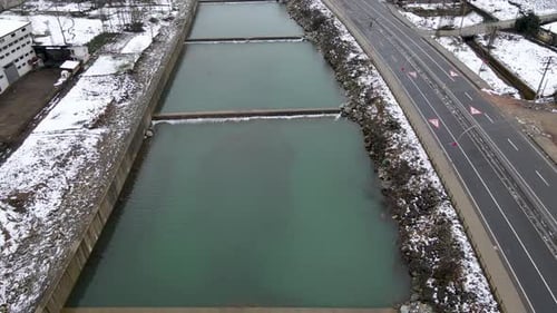 Aerial View of River Flowing Through Concrete Channels