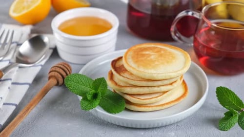 Stack of Pancakes with Honey and Red Tea
