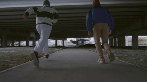 Acrobatic Pair Performing Synchronised Tumbling Under Structure