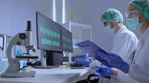 Scientists Reviewing DNA Data in Modern Laboratory
