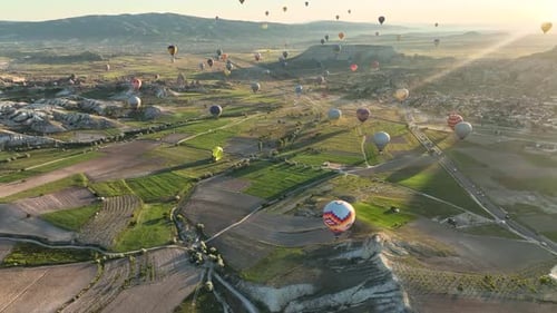 4K Aerial view of Goreme. Colorful hot air balloons fly over the valleys.