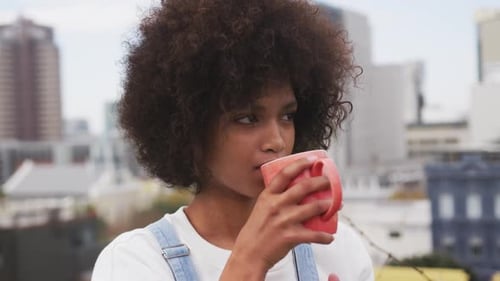 Front view of mixed race woman on rooftop