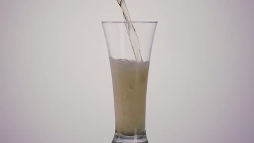 A hand of a drunk man pouring beer