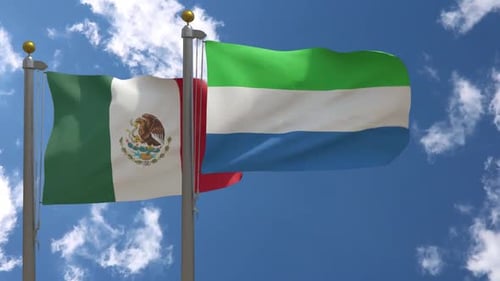 Flags of Mexico and Sierra Leone Waving in Clear Sky