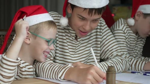 Children Write Letters Wearing Santa Hats