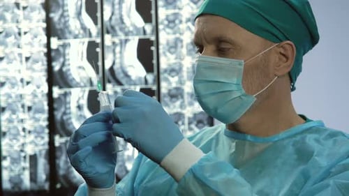 Medical Professional Preparing a Syringe in Hospital