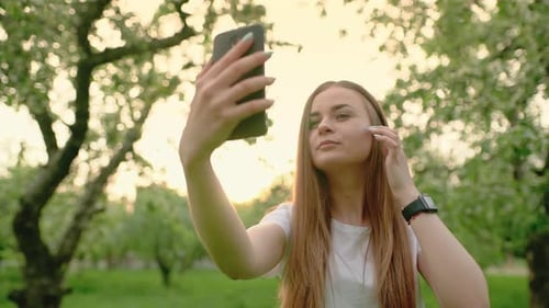 Attractive Woman Taking Selfies in a Green Park