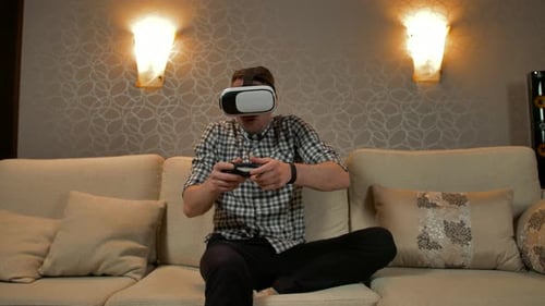 Man Immersed in Virtual Reality Gaming at Home