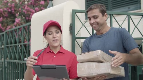 Cheerful Courier Girl in Red Cap Delivering Package