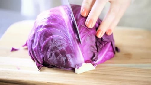 Red Cabbage Being Cut in Half