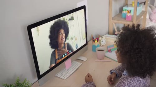 Child Engages in Cheerful Video Call on Computer