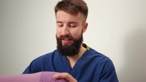Physical Therapist Working with Patient's Leg