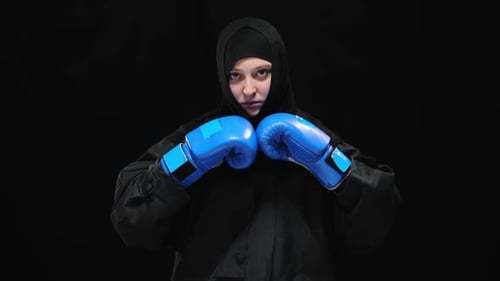 Woman with Boxing Gloves in Black Outfit