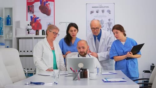 Medical Staff Viewing a Laptop in an Office