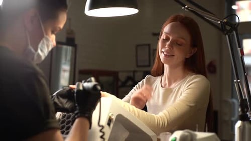 Woman Getting Manicure in Nail Salon