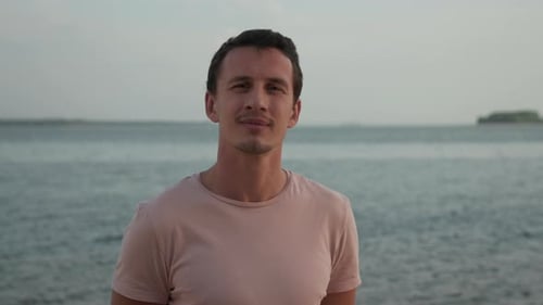 Man Posing on the Beach Near the Water
