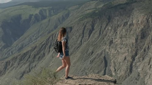 Successful Woman Comes To the Cliff of the Mountain and Raises Her Hands Up