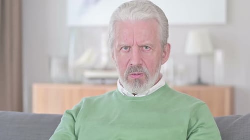 Senior Man Experiencing Headache Indoors