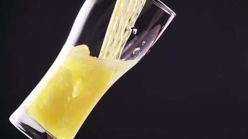 Refreshing Golden Liquid Being Poured Into Glass