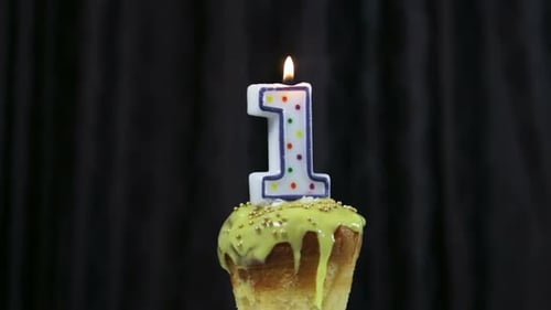 Cupcake with Number One Candle Being Lit