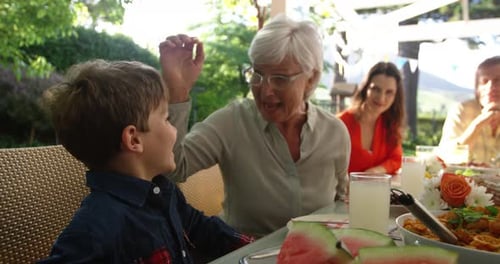Family Enjoys a Meal Together Outdoors