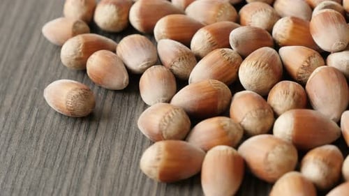 Pile of Hazelnuts on a Wooden Surface