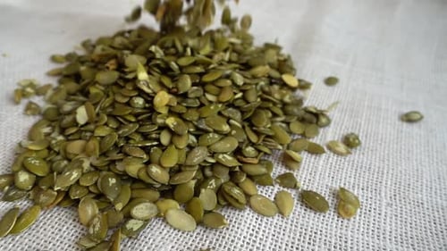 Pumpkin Seeds Falling on Burlap
