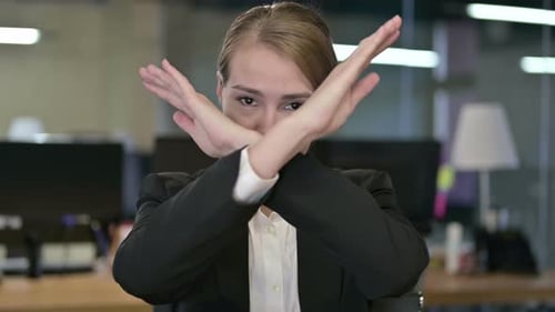 Portrait of Young Businesswoman Saying No By Hand Gesture