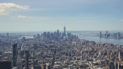 Panoramic view of Manhattan with the One World Trade Center and the Statue of Liberty in the distanc