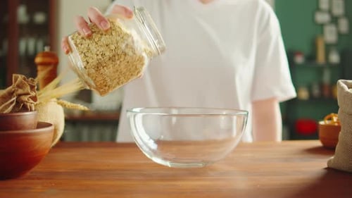 Grocery Putting Cornflakes in Bowl Closeup