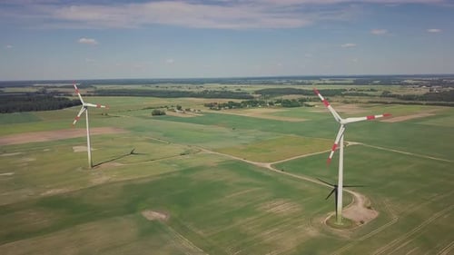 Wind Turbines Rotating in a Green Rural Field