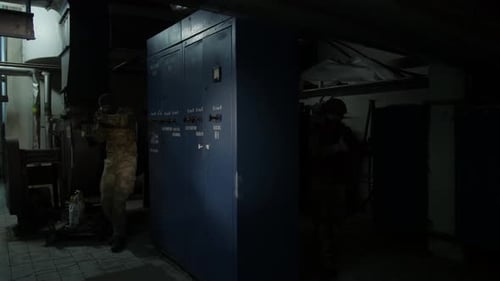 Soldiers in Camouflage Gear with Weapons in Dark Setting