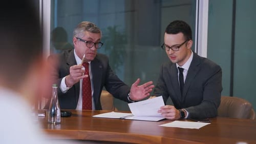 Businessmen Discussing at a Meeting in the Office
