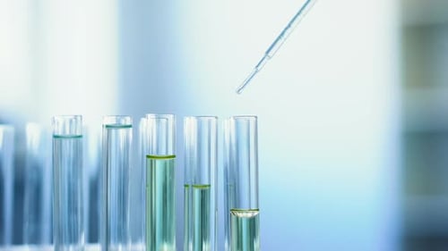 Liquid Being Dripped Into Test Tube in Lab