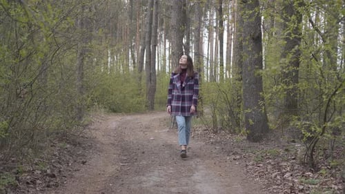 Charming Caucasian Woman Walking Along Forest Alley To the Camera. Portrait of Beautiful Brunette