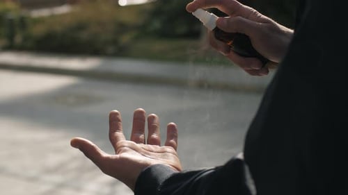 Man Use Sanitizer on the Street